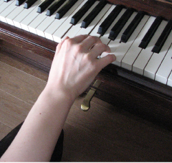 Pianoa soittava käsi.